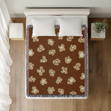 Atia Cheetah Print Cotton Throw Blanket in Rust Brown and Beige, on a bed