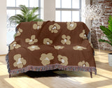Atia Cheetah Print Cotton Throw Blanket in Rust Brown and Beige, draped over a sofa