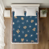 Atia Cheetah Print Cotton Throw Blanket in Teal and Beige, on a bed