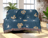 Atia Cheetah Print Cotton Throw Blanket in Teal and Beige, draped over a sofa