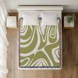 Binitie Zebra Print Cotton Throw Blanket in Chartreuse, on a bed