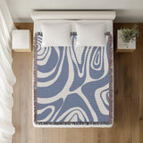 Binitie Zebra Print Cotton Throw Blanket in Light Blue, on a bed