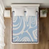 Binitie Zebra Print Cotton Throw Blanket in Sky Blue, on a bed