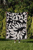 Booker Floral Cotton Throw Blanket in Black, outdoors