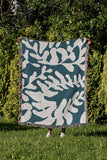 Booker Floral Cotton Throw Blanket in Teal, outdoors