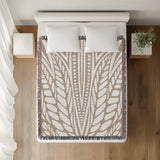 Buga Abstract Print Cotton Throw Blanket in Beige, on a bed