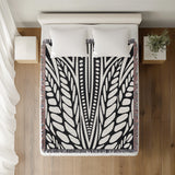 Buga Abstract Print Cotton Throw Blanket in Black, on a bed
