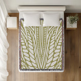 Buga Abstract Print Cotton Throw Blanket in Chartreuse, on a bed