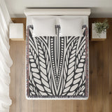 Buga Abstract Print Cotton Throw Blanket in Gray, on a bed
