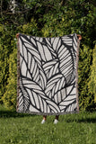 Caro Floral Cotton Throw Blanket in Black, outdoors