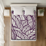 Caro Floral Cotton Throw Blanket in Purple, on a bed