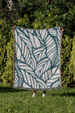 Caro Floral Cotton Throw Blanket in Teal, outdoors