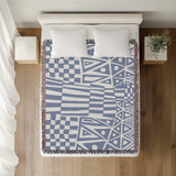 Cocodili Abstract Print Cotton Throw Blanket in Light Blue, on a bed