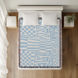 Cocodili Abstract Print Cotton Throw Blanket in Sky Blue, on a bed
