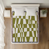 Colette Checkered Cotton Throw Blanket in Chartreuse, on a bed