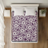 Dandelion Floral Cotton Throw Blanket in Purple, on a bed
