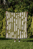 Deka Abstract Cotton Throw Blanket in Chartreuse, outdoors