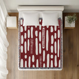 Deka Abstract Cotton Throw Blanket in Red, on a bed