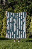Deka Abstract Cotton Throw Blanket in Teal, outdoors