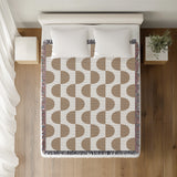 Demi Geometric Cotton Throw Blanket in Beige, on a bed