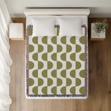 Demi Geometric Cotton Throw Blanket in Chartreuse, on a bed