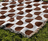 Demi Geometric Cotton Throw Blanket in Rust Brown, outdoors