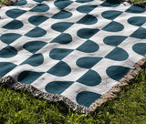Demi Geometric Cotton Throw Blanket in Teal, outdoors