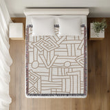 Diof Abstract Print Cotton Throw Blanket in Beige, on a bed
