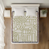 Diof Abstract Print Cotton Throw Blanket in Chartreuse, on a bed