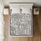 Diof Abstract Print Cotton Throw Blanket in Gray, on a bed