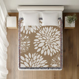 Fiesta Floral Cotton Throw Blanket in Beige, on a bed