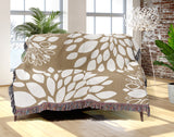 Fiesta Floral Cotton Throw Blanket in Beige, draped over a sofa