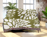 Fiesta Floral Cotton Throw Blanket in Chartreuse, draped over a sofa