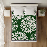 Fiesta Floral Cotton Throw Blanket in Green, on a bed