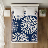 Fiesta Floral Cotton Throw Blanket in Navy Blue, on a bed