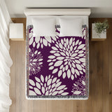 Fiesta Floral Cotton Throw Blanket in Purple, on a bed