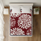 Fiesta Floral Cotton Throw Blanket in Red, on a bed