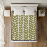 Freda Hand Woven Throw Blanket in Chartreuse, on a bed