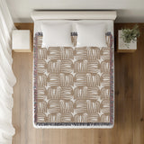 Hami Cotton Throw Blanket in Beige, on a bed