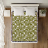 Hami Cotton Throw Blanket in Chartreuse, on a bed
