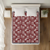 Hami Cotton Throw Blanket in Red, on a bed