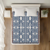 Idia Geometric Cotton Throw Blanket in Blue, on a bed