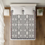Idia Geometric Cotton Throw Blanket in Gray, on a bed