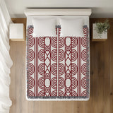 Idia Geometric Cotton Throw Blanket in Red, on a bed