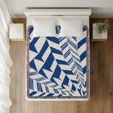 Kafi Abstract Cotton Throw Blanket in Blue, on a bed