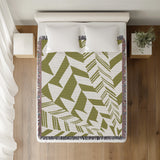 Kafi Abstract Cotton Throw Blanket in Chartreuse, on a bed