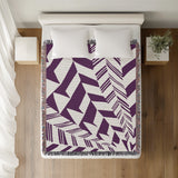 Kafi Abstract Cotton Throw Blanket in Purple, on a bed