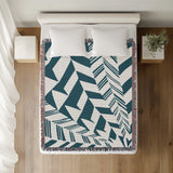 Kafi Abstract Cotton Throw Blanket in Teal, on a bed
