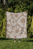 Kio Abstract Print Cotton Throw Blanket in Beige, outdoors