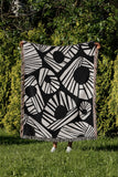 Kio Abstract Print Cotton Throw Blanket in Black, outdoors